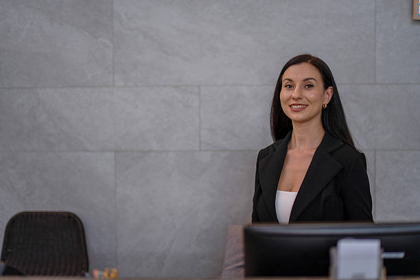 istock A receptionist is working at the hotel's counter. 2236903942