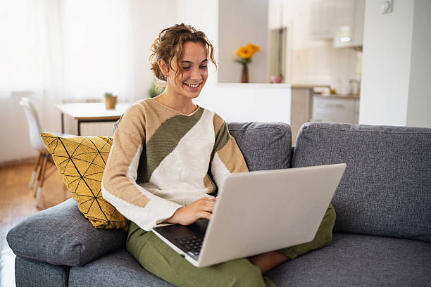 istock Young woman studying on laptop at home 2236904521