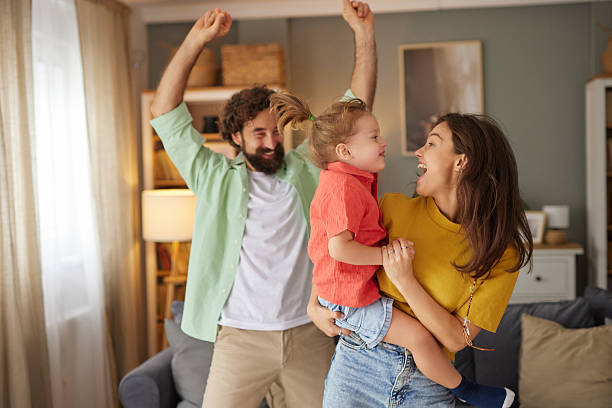 istock Happy family dancing together having fun at home 2236904585