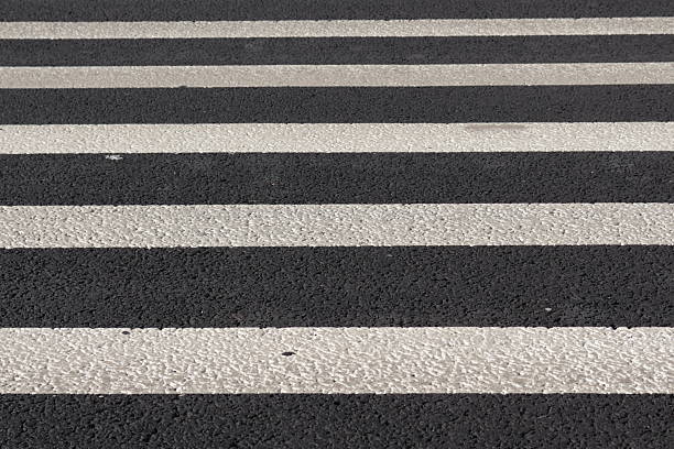 istock Zebra road markings on an asphalt road, background. 2236905454