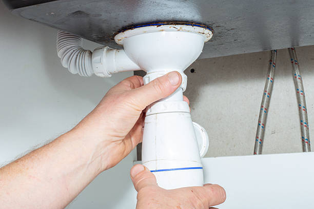 istock A plumber connects a white PVC drain pipe under a sink during a plumbing repair 2236907123