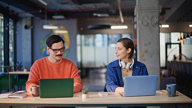 istock Smiling colleagues acquaintance workplace creative agency closeup. Two coworkers 2236909861