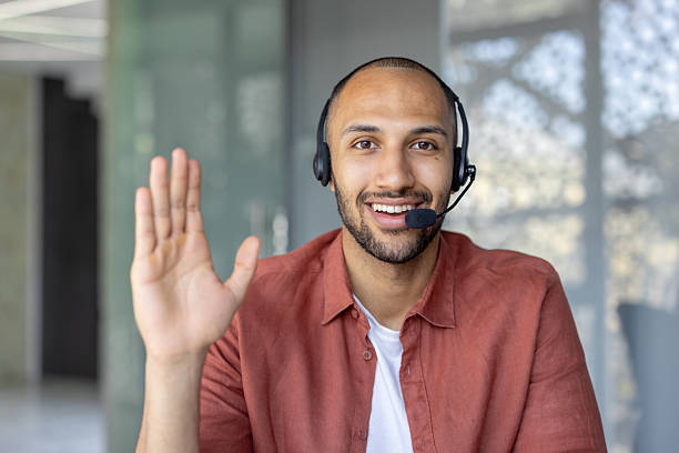 istock The smiling man with a headset greets the viewer during his video call, making a positive connection. 2236912461