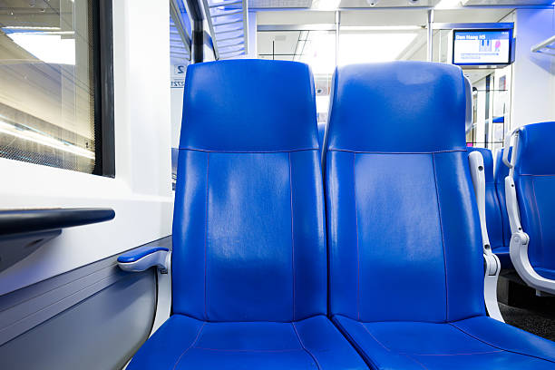 This image shows a closeup of blue and white transit vehicle seats, highlighting urban travel comfort and design