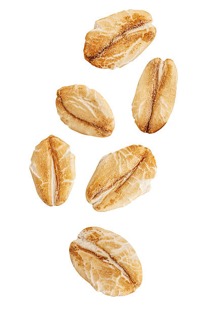 istock Rolled Oat flakes  explosion. Levitating oatflakes shattering isolated on white background. Falling oats and crumbs  2236914808