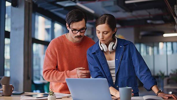 istock Thoughtful team members pondering solutions looking laptop in workspace closeup. 2236915121