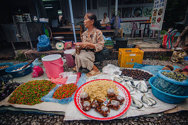 A market vendor surrounded by her goods at Luang Prabang’s morning market. September 2025
