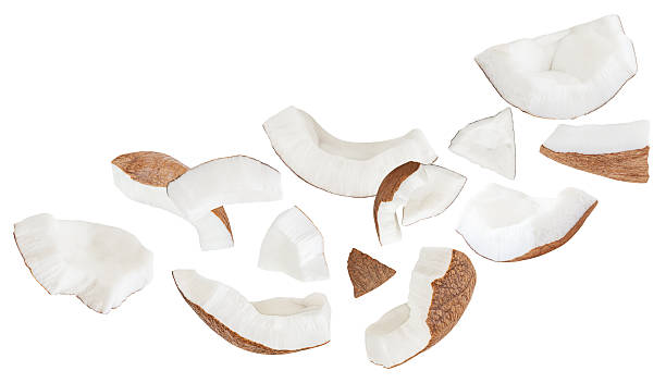 istock Coconut Explosion. Flying Coconut pieces  isolated on white. High-Quality Coconut  slices and chunks in the air. Top view. Flat lay. Pattern  2236915430