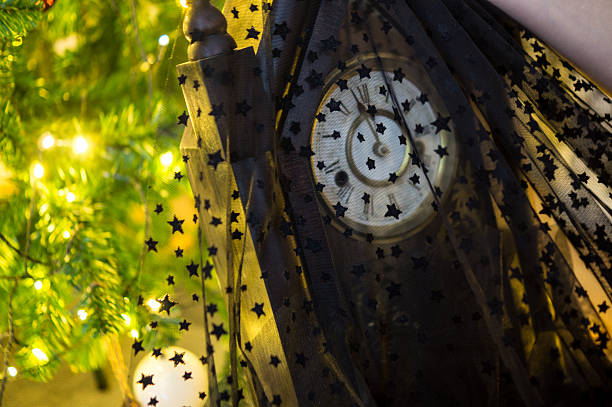 Clock hands about to strike midnight on New Year's Eve