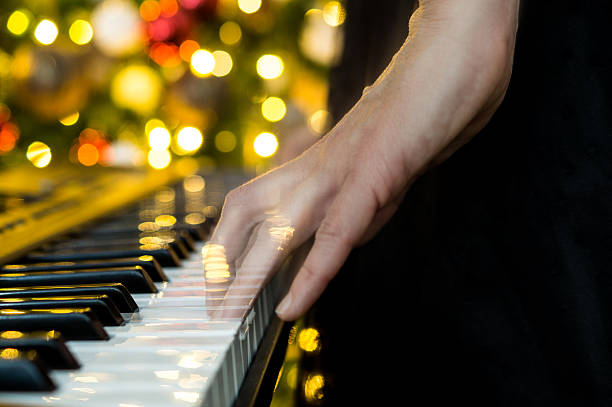istock pianist playing in front of tree with hands blurred in ghost effect 2236917328