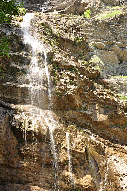 istock A waterfall cascading down a stone cliff, creating a picturesque natural landscape 2236917599