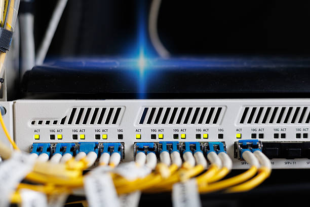 istock Yellow coiled fiber optic patch cord with blue connectors SFP modules are essential for high-speed data transmission over fiber optic networks. 2236919306