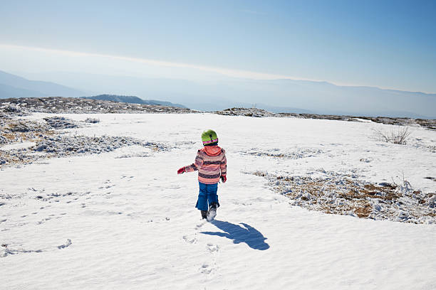 Beautiful girl on skiing, relaxing on the top of the mountain. Copy space.