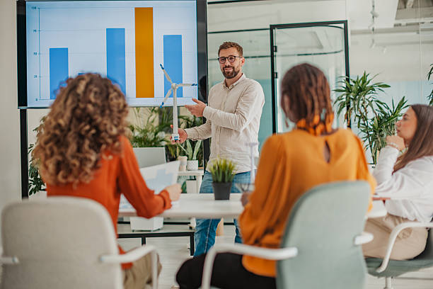istock Young people collaborating and strategizing in a bright startup office setting to boost business growth 2236920406