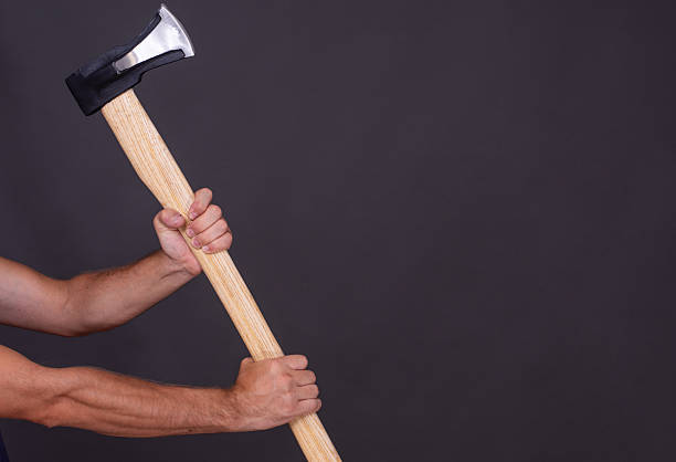 istock Wood chopping axe in hand on grey background 2236920511