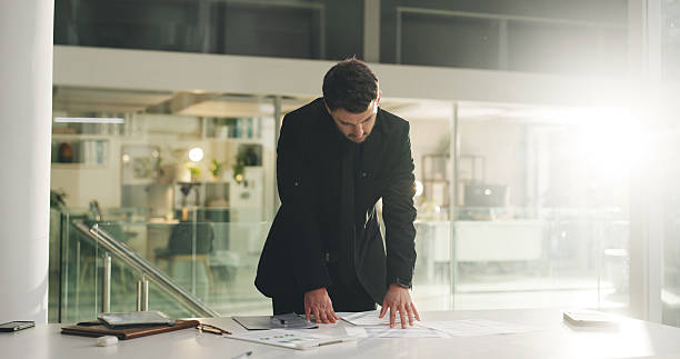 istock Business, man or reading paperwork at night for accounting data, organize info and forecasting. Flare, financial analyst or graph documents with overtime in office for investment analysis or deadline 2236920967