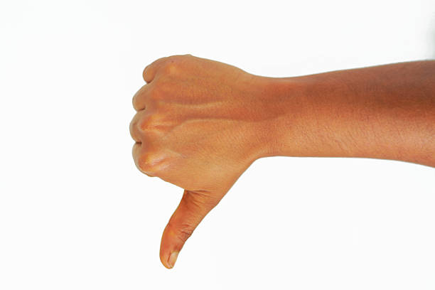 Real Hand Showing Unlike, Dislike, Thumb down, bad mean on white Background.