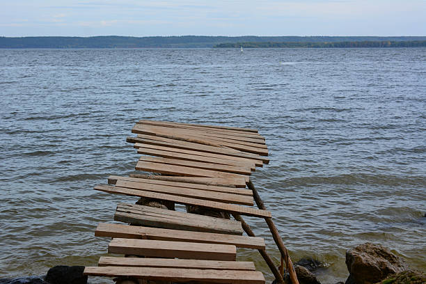 Weathered Wooden Pier Extending into a Calm Lake