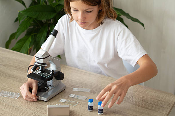 istock Girl studying biology at home while exploring plant samples with a microscope 2236922134