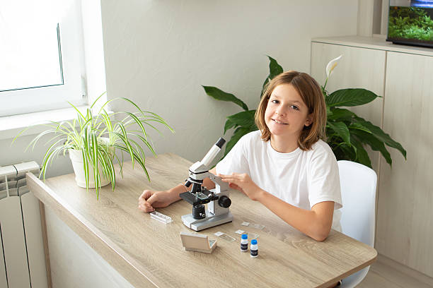 istock Girl studies biology at home using a microscope to explore plant specimens for online education 2236922161