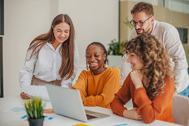 istock Young professionals collaborate happily at a startup office, sharing ideas and technology during a planning session 2236923086