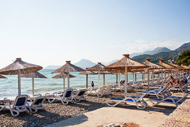 istock Beach with straw umbrellas and sunbeds 2236923998