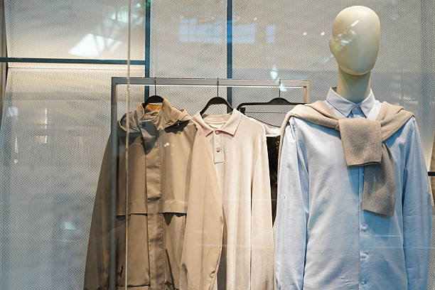 istock a store mannequin dressed in neutral and pastel clothing with additional garments 2236924045