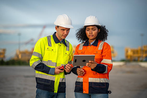 istock Industrial engineer operations marine port cranes loading and unloading of cargo ships global trade and supply chain import export environment monitoring responsible global economy. 2236924695