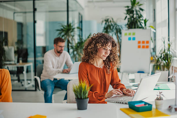 istock Young professionals collaborate in a vibrant startup office filled with plants and bright ideas 2236925885