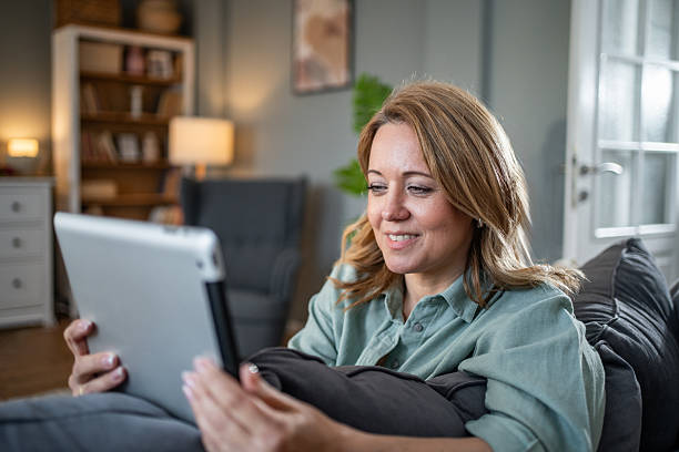 istock Woman relaxing at home using digital tablet technology 2236926848