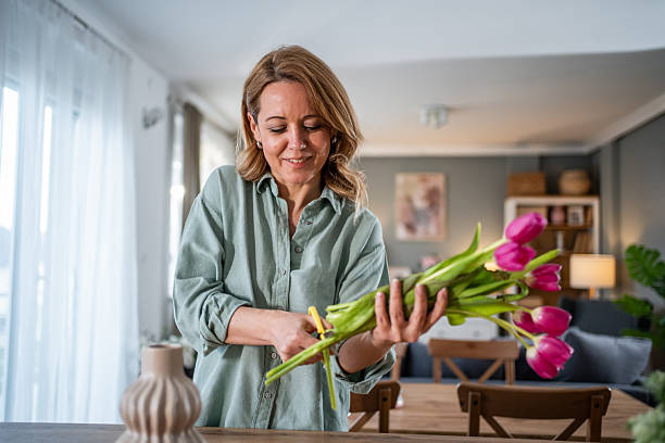 istock Woman arranging fresh tulips creating home decor 2236926864