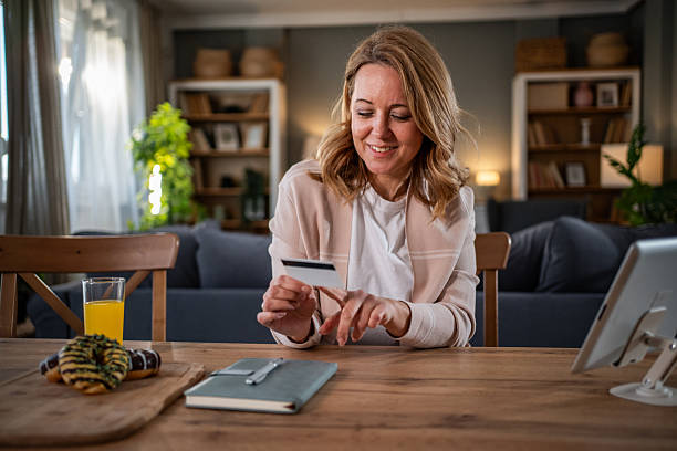 istock Woman making online purchase on tablet with credit card 2236928096