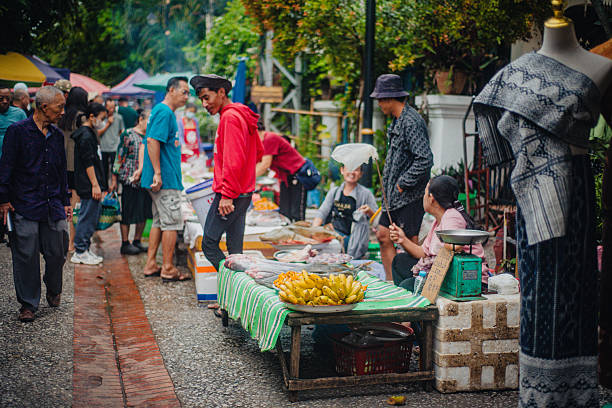 Early morning bustle at Luang Prabang’s market, where locals trade fresh produce and daily essentials. September 2025