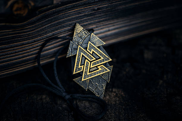 istock Ancient Nordic Symbol Rune Design Featuring Valknut Sign on dark aged background 2236930624