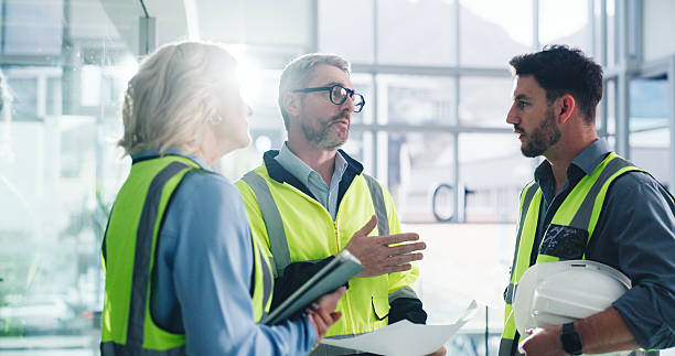 istock Teamwork, architect and people with blueprint in office, talk and planning for property development. Civil engineer, woman and man with document for architecture, flare and discussion for renovation 2236931368