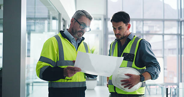 istock Civil engineer, talk and men with blueprint, conversation or collaboration for property development. Architect, project or people with floor plan for architecture, flare and discussion for renovation 2236931372