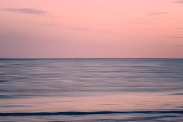 istock Soft pink sky over still ocean 2236935213