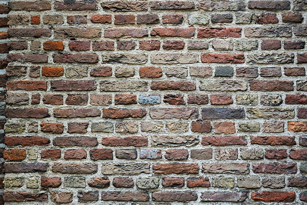 Old, weathered, colorful brick wall pattern or background. Front view, close up, no people