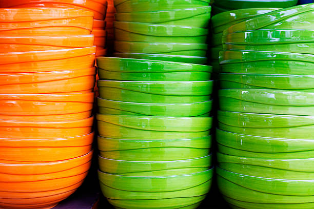 Close-up of sophisticated table settings with plates, cutlery, bowls, and glasses for beautiful events and dinners.