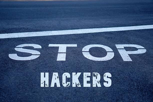 istock stop hackers. words written on the pavement, on a traffic sign 2236939003