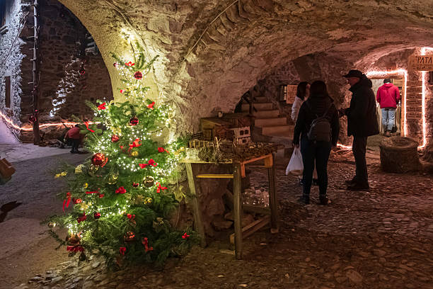 People visit the Christmas market set under the arcades and in the old stone houses of Rango, one of the most characteristic villages in Trentino, northern Italy