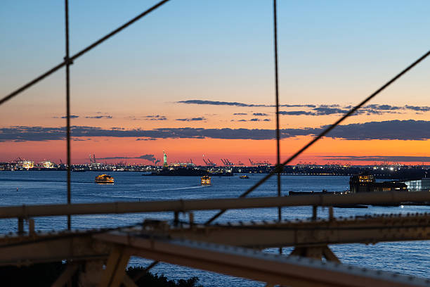 The Statue of Liberty on the Horizon. Viewed from the Brooklyn Bridge