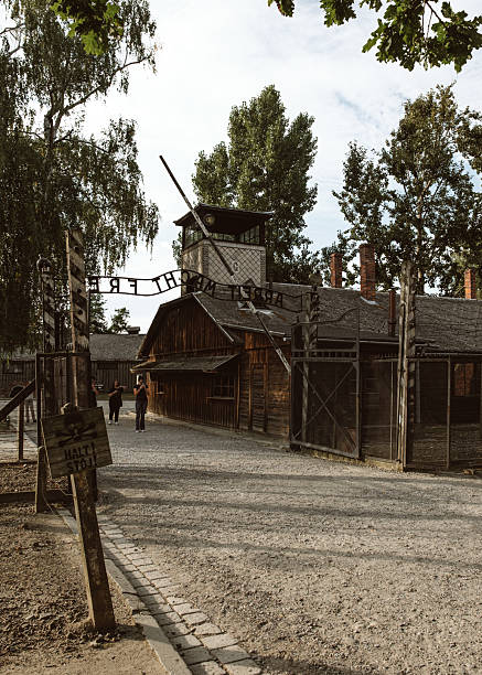 Auschwitz Birkenau, Poland, 30 August 2025, Visitors walk through the gate of a concentration camp, reflecting on the solemn history of the concentration camp