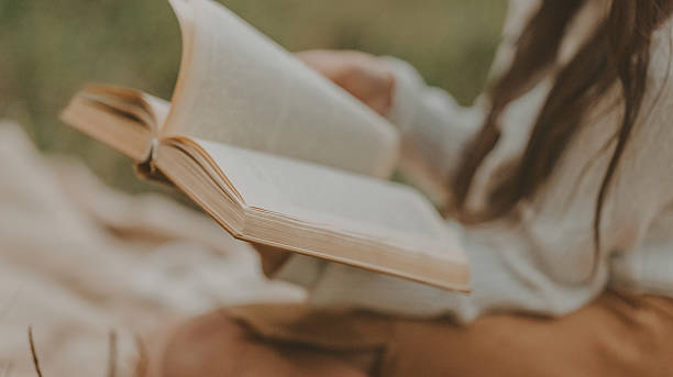istock Reading a book outdoors 2236947341