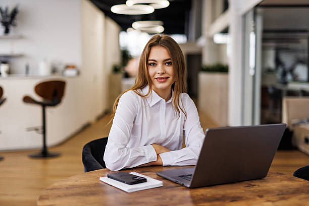 istock Young beautiful joyful woman smiling while working with laptop in office 2236948272