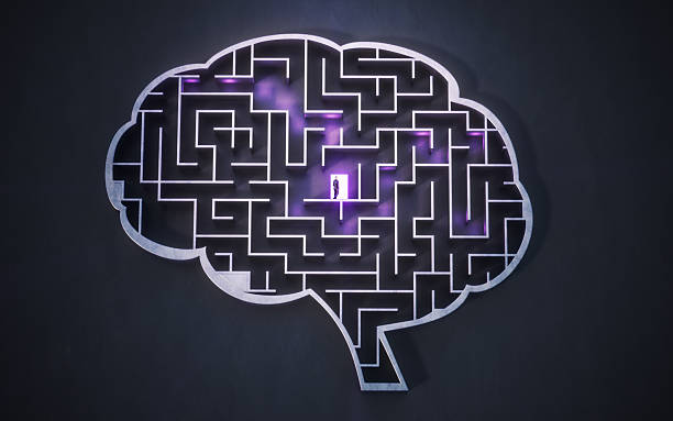 istock Businessman in a Dark Concrete Maze Shaped Like a Human Brain, Looking for a Solution on a Purple-Lighted Path 2236948613