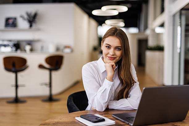 istock Young beautiful joyful woman smiling while working with laptop in office 2236948929