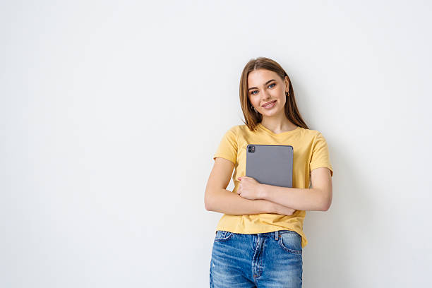 istock Smiling woman with tablet pc, isolated on white background 2236950323