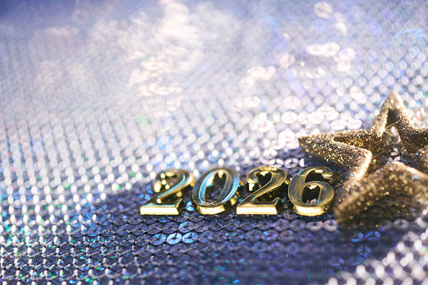 istock Golden 2026 Numbers with Glittery Star on Sparkling Blue Sequin Background 2236951206
