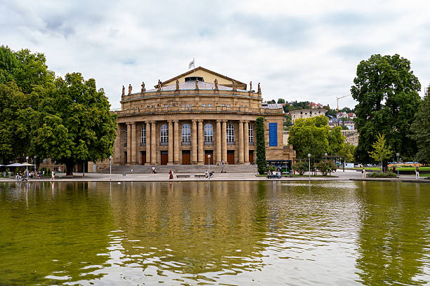 The Stuttgart State Opera House (Staatstheater Stuttgart) with its neoclassical facade, reflected in the Eckensee pond in Stuttgart, Germany. Built in the early 20th century, it is one of the most important opera houses in Europe and home to opera, ballet, and theater performances. Photographed on August 31, 2025.